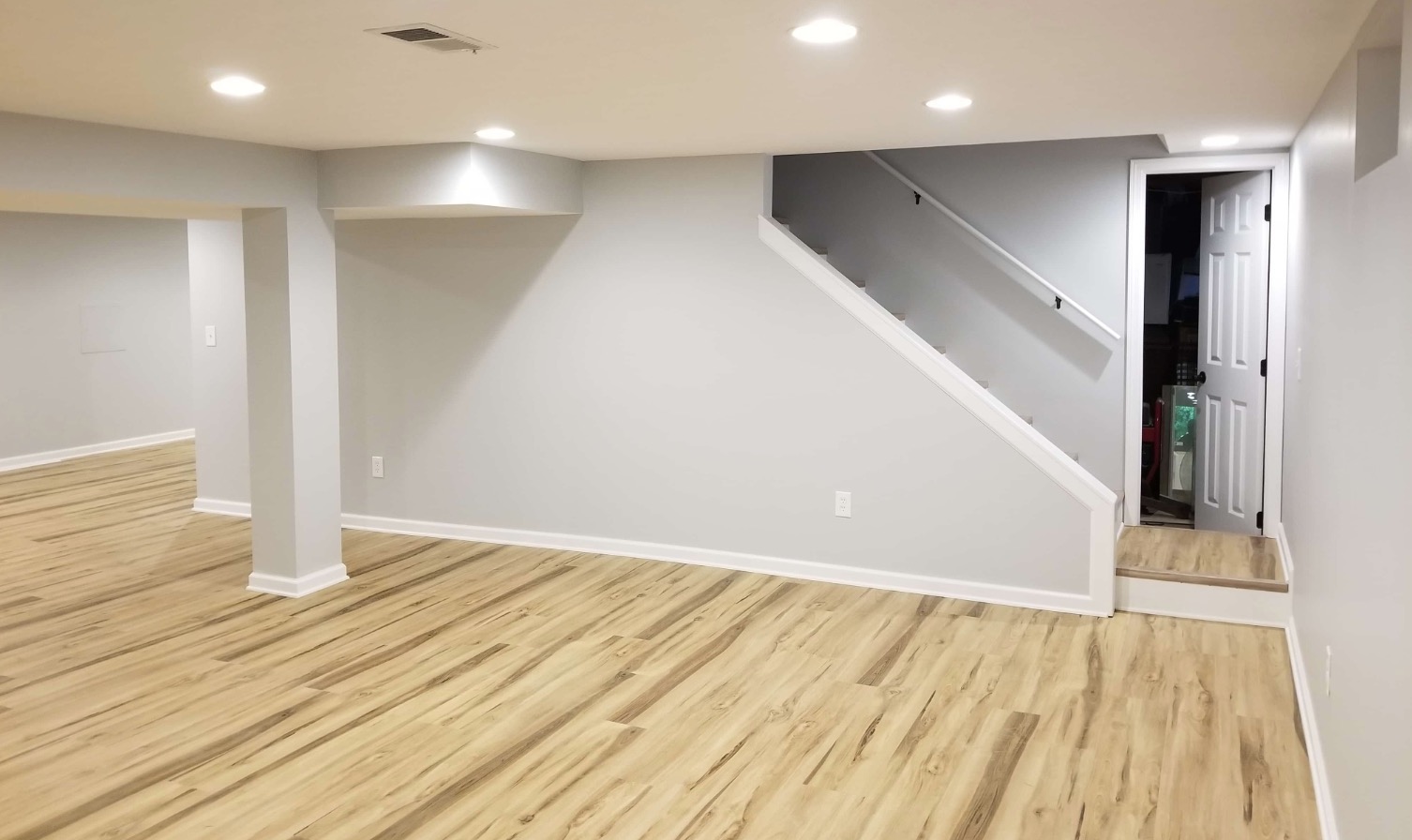 Basement renovation with recessed lighting and modern finishes